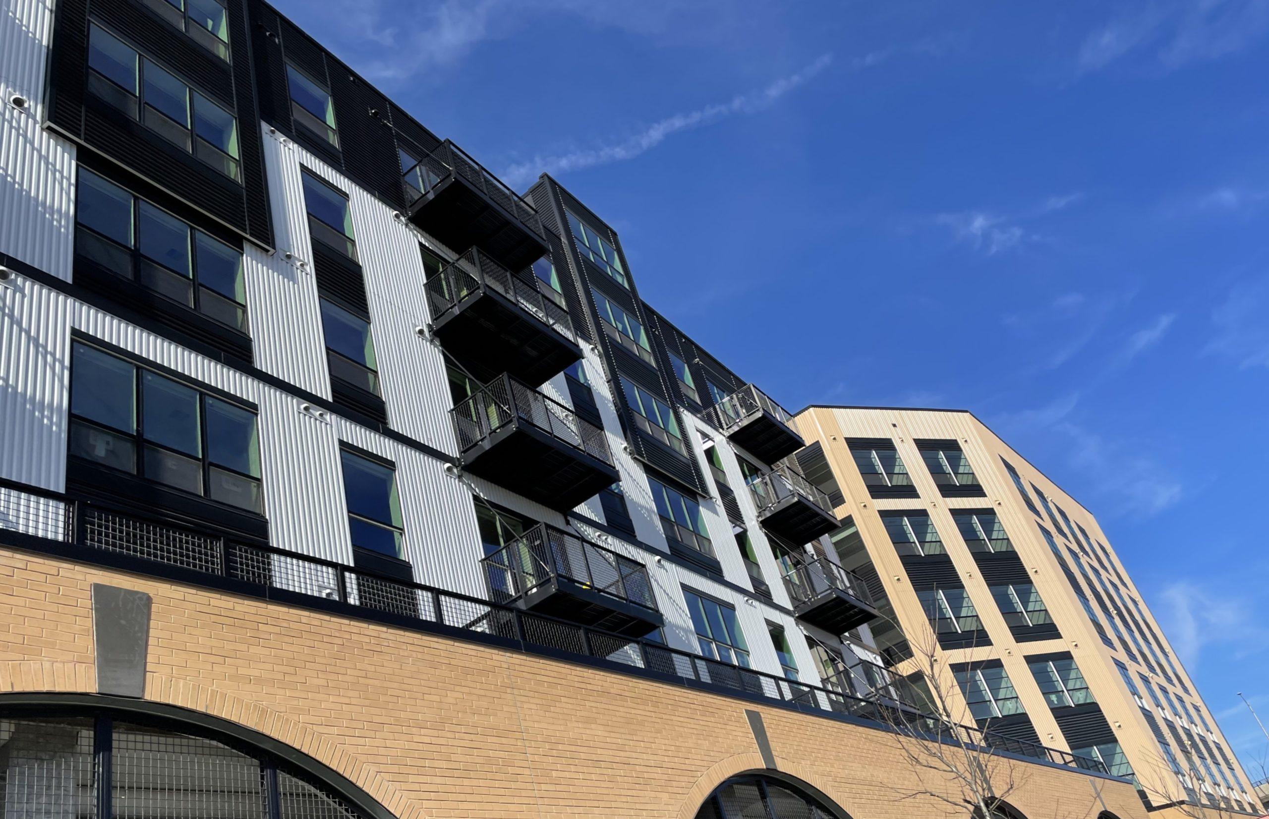 Brick and metal residential building under a clear sky