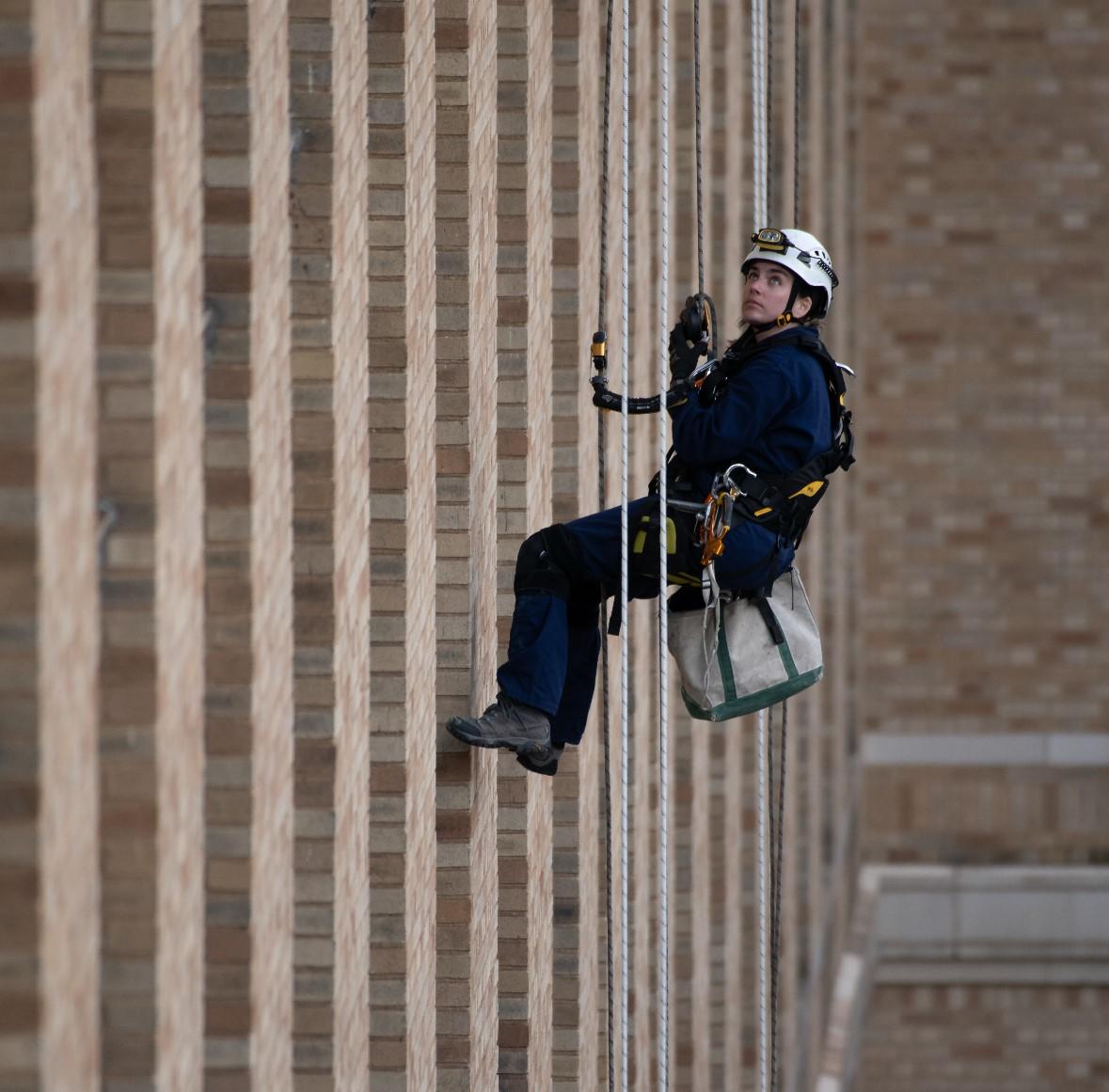 Building specialist inspecting an existing masonry facade